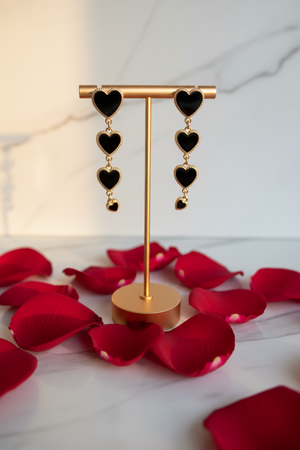 Azvera Studio Amour Drop Earrings featuring elegant gold-toned dangle design on a white background.