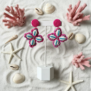 Azvera Studio Shella Cowrie Drop Earrings featuring white cowrie shells and delicate gold hooks on a white background.