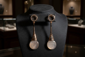 Azvera Studio Luna Drop Earrings hanging from ears, featuring sleek silver design with a moon-shaped drop for elegant style.